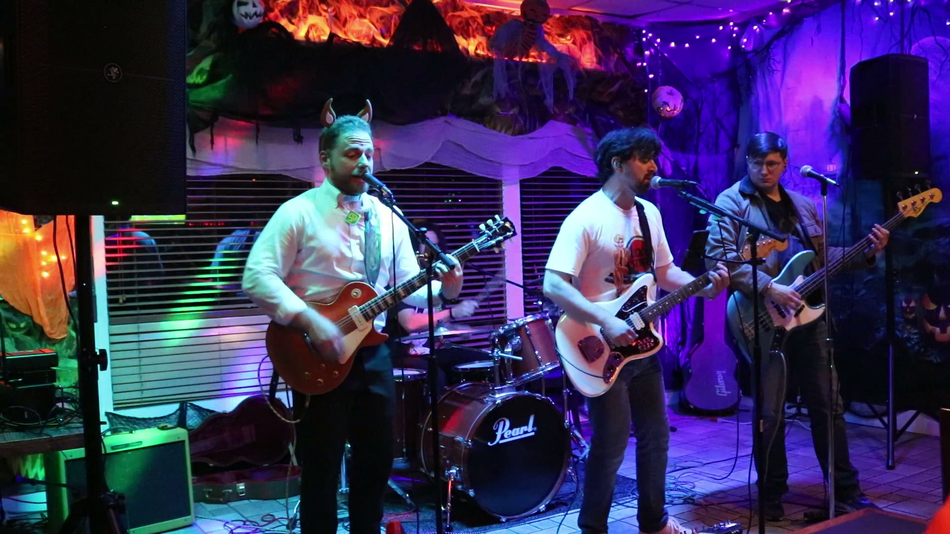 Perfect Blue performing onstage under blue and purple lights